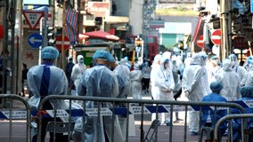 Health workers prepare to conduct a COVID-19 test for people in Hong Kong. - Powered by Shutterstock - Get 15% off with code: PIKWIZARD15