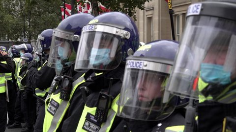 London , United Kingdom (UK) - 09 26 2020: Riot police wearing face masks and helmets stand in a line