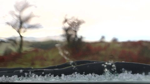 Hailstones in front of the car window.