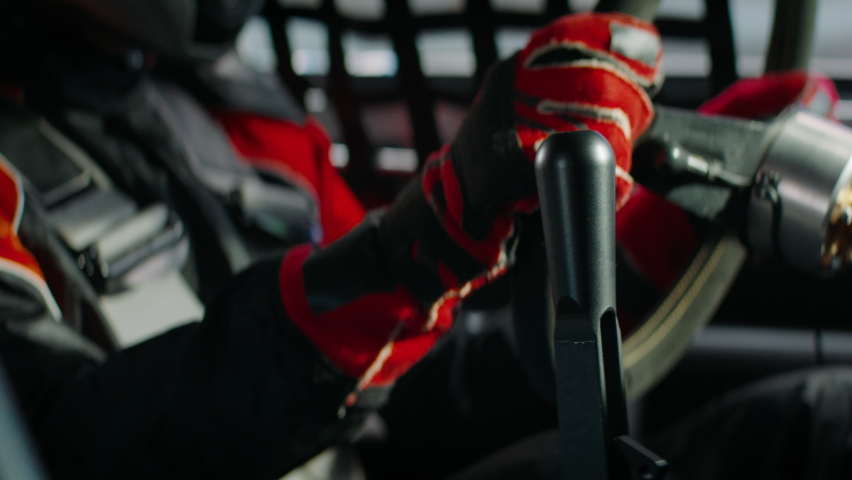 CU on gear shifter, driver of sports car driver starting a race on a speedway. Shot with 2x anamorphic lens Royalty-Free Stock Footage #1066088185