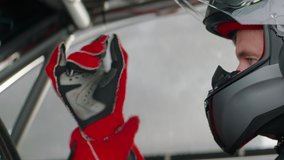 CU portrait of sports car driver closing helmet visor, starting a race on a speedway. Shot with 2x anamorphic lens - Powered by Shutterstock - Get 15% off with code: PIKWIZARD15