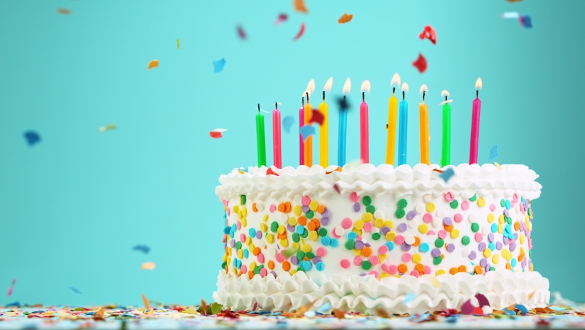 Birthday Cake With Burning Colorful Candles on Pastel Blue Background. Super Slow Motion, 1000 FPS. Royalty-Free Stock Footage #1066088707
