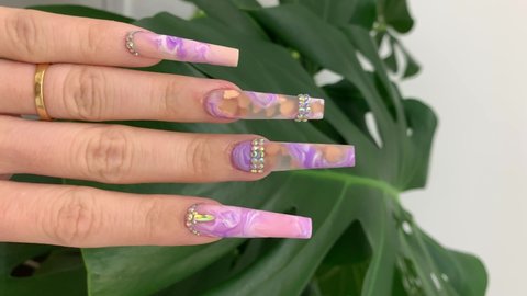 close look of beautiful nail marble nails design on long nails