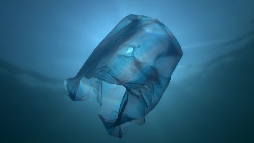 Plastic pollution, used blue plastic bag slowly drifting underwater in the sun lights. Backlighting (Contre-jour). Plastic debris underwater. Plastic garbage environmental pollution problem of Ocean  | Shutterstock HD Video #1066089238