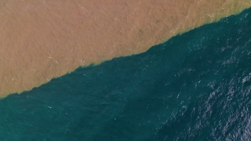 Oil release into the ocean.
Dirty Polluted Water flowing into a blue Ocean from a Sewage outlet close to the beach. 
Environmental Protection, dirty sea concept, aerial shot. | Shutterstock HD Video #1066092472