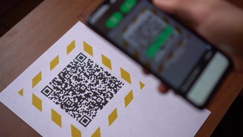 Scanning the QR code on the display using a smartphone. Internet URL, encrypted data, e-ticket, menu, contactless payment, citizen ID card, pass