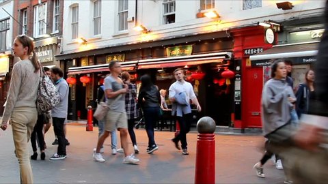 LONDON , UK - JUNE 7: Hundreds of tourists and locals  at the streets of Chinatown in evening time  on June 7, 2015 in London, United Kingdom. Time lapse