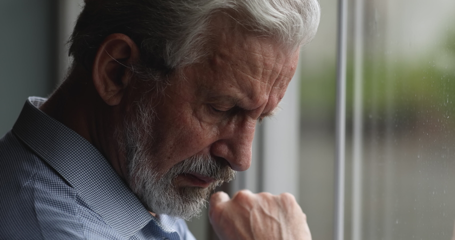 Close up sad elderly man face looking out the window, yearning about past recollect memories. Lonely abandoned grey-haired bearded grandfather suffer about disorder or incurable senile disease concept | Shutterstock HD Video #1066102126