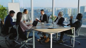 Interracial business staff engaged in corporate meeting. Company colleagues coolabgorating in boardroom brainstroming solving issues together. Teamwork. - Powered by Shutterstock - Get 15% off with code: PIKWIZARD15
