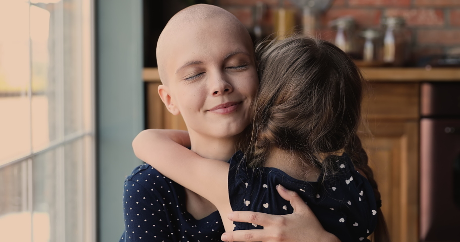 Close up young female bald cancer patient loving mom cuddling her little daughter feeling love receive support, kid rear back view, meaning of live, motivation for oncology disease struggle concept Royalty-Free Stock Footage #1066120999