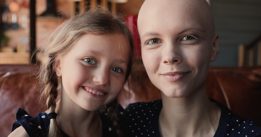 Little adorable girl her young bald mother making heart shape with hands showing symbol of love at camera, close up view happy faces. Share support optimism and hope with other cancer patients concept | Shutterstock HD Video #1066121233
