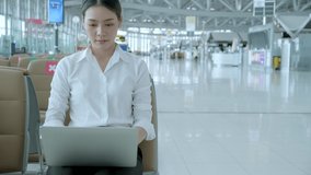 Social distancing, businesswoman wearing face mask sit working with laptop keeping distance away from each other to avoid covid19 infection during pandemic. Empty chair seat red cross shows new normal - Powered by Shutterstock - Get 15% off with code: PIKWIZARD15