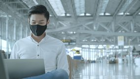 Social distancing, businessman wearing face mask sit working with laptop keeping distance away from each other to avoid covid19 infection during pandemic. Empty chair seat red cross shows new normal l - Powered by Shutterstock - Get 15% off with code: PIKWIZARD15