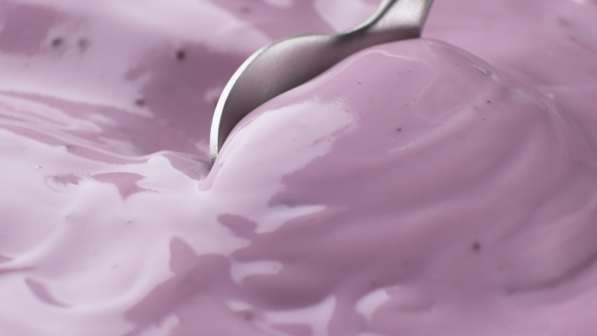 Fresh berry yogurt with spoon, blueberry yogurt close up | Shutterstock HD Video #1066128784