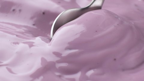 Fresh berry yogurt with spoon, blueberry yogurt close up