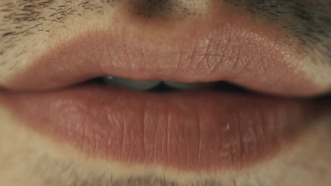 Male lips chewing gum. Closeup on mouth