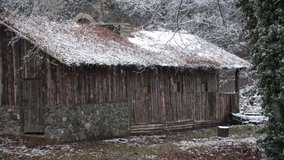 Old European peasant house in snowfall in Poland