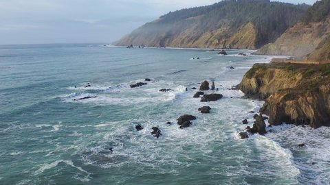 The rough waters of the Pacific Ocean wash against the rocky Northern California coastline north of Fort Bragg. The scenic Pacific Coast Highway runs along this amazing part of the west coast.