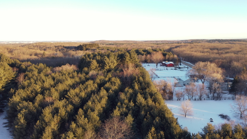 Aerial view of Kettle Moraine State forest in Wisconsin in Winter. Black  car driving on the road 