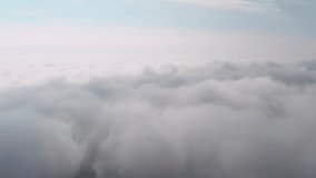 Aerial view of the sky and clouds that the camera flies into