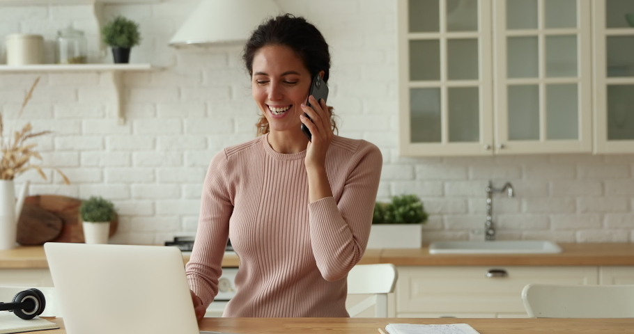 Excited young woman answering cellphone call, hearing good news. Overjoyed millennial lady celebrating getting dream job offer or bank loan approval from manager by smartphone communication. | Shutterstock HD Video #1066149835