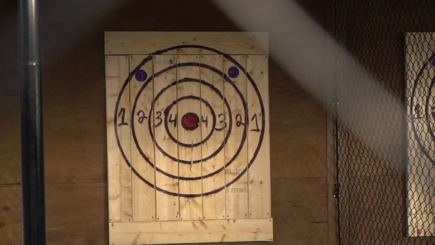 Axe throwing target cages with two people throwing axes in slow motion Royalty-Free Stock Footage #1066154056