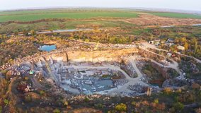 Extraction of minerals with the help of special equipment near a small lake in the warm evening light in picturesque Ukraine. Aerial UHD 4K drone realtime video, shot in 10bit HLG and colorized