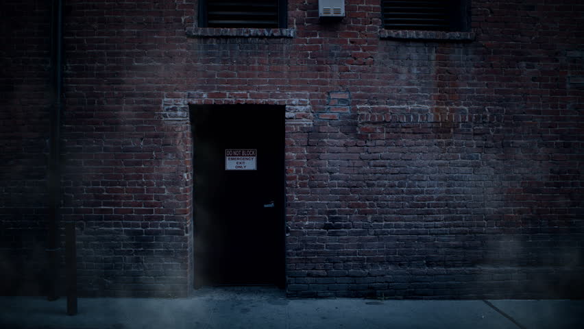 Back Door Entrance To Old Brick Building In Alley With Steam Rising