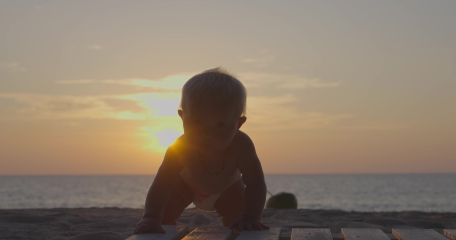 Baby on the beach during the sunset  and coconut  | Shutterstock HD Video #1066172407