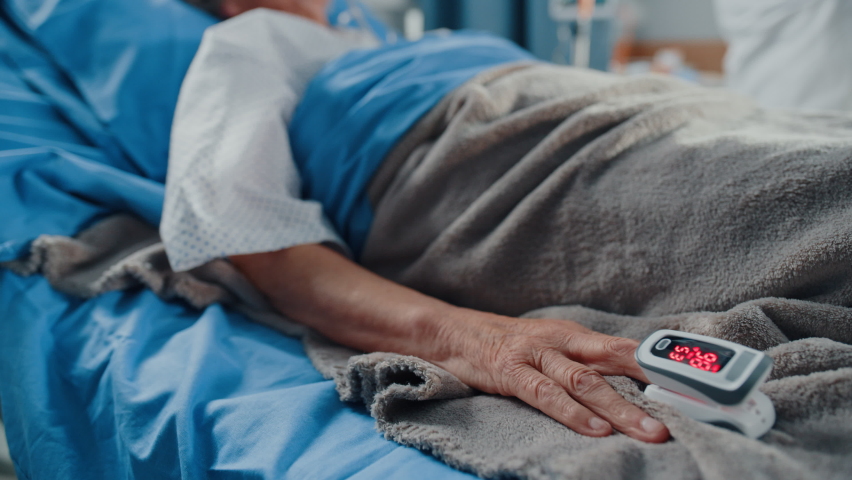 Hospital Coronavirus Emergency Department Ward: Doctor wearing Coverall, Face Mask Writes Down Vitals of Senior Female Patient with Oxygen Mask Resting in Bed. Paramedics Saving Lives. Elevating Shot | Shutterstock HD Video #1066174426