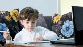 Arabic kid using laptop for learning from home