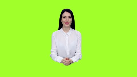 Stylish female news presenter reporting in tv studio against green screen background, Chroma key 4k pre-keyed footage