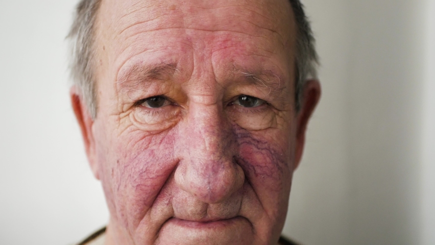 elderly man looking at the camera, face close up 4K