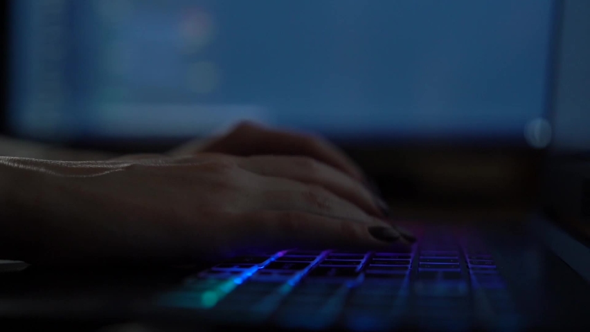 Software developer freelancer woman female hands work with program code C++ Java Javascript on wide displays at night Develops new web desktop mobile application or framework Projector background