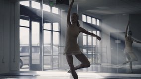 Woman practicing contemporary dancing near mirror in dance studio , Lehi, Utah, United States