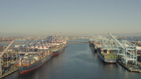 Long Beach, California, USA - January 21st, 2021: Aerial, drone footage of a massive container ships docked at Long Beach port