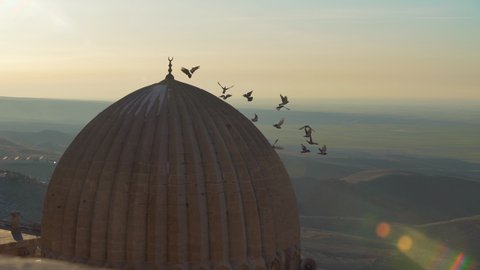 Zinciriye Madrasah dome and Mardin City Landscape in Turkey. Birds Flying