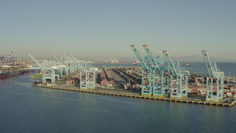 Long Beach, California, USA - January 21st, 2021: Drone view of massive cranes in the Long Beach port