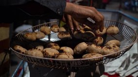 A slo motion clip of the hands of a man making Litti - indian street food