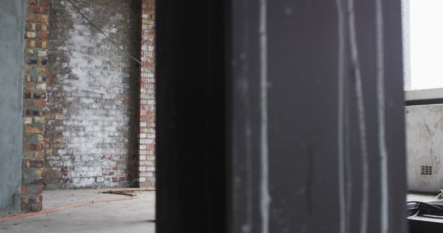 Shirtless african american man exercising with medicine ball in an empty urban building. urban fitness and healthy lifetyle.