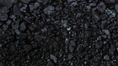Super Slow Motion Shot of Crushing Coal on Black Background at 1000 fps.