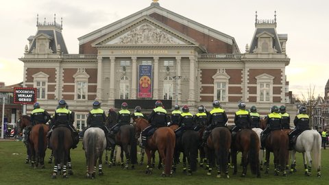 Amsterdam, Netherlands, January 24, 2021. Mounted riot police in front of historic Concert building during corona riots.