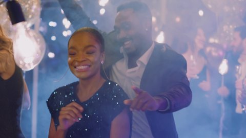 Beautiful nice joyful african american woman with man dancing together among business crowd. Corporate party. Formal event. Celebration. Video stock
