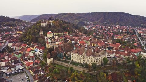 Aerial panoramic view of old city of Sighisoara during cloudy weather, Romania