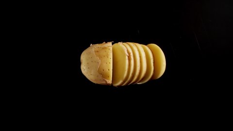 Cutting A Fresh Potato On A Black Table, Stop motion