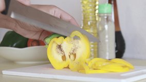 Cooking in the kitchen, Use a knife to cut the bell pepper.