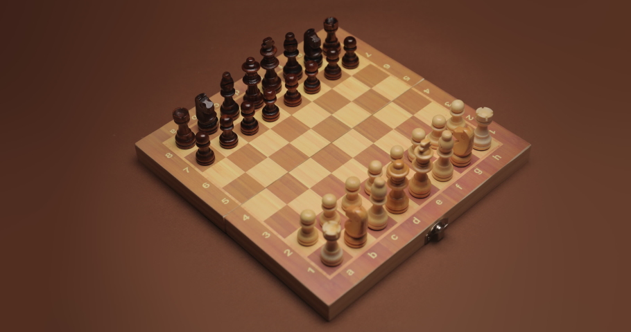 Playing chess on color background. The Queen Gambit opening