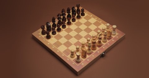 Playing chess on color background. The Queen Gambit opening