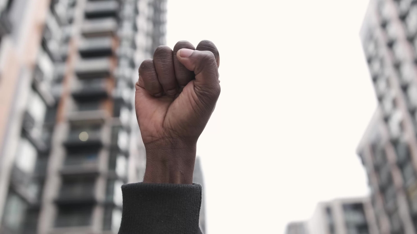 Raised first in solidarity for equality and justice for all. Peaceful protest for equality and positive change. Black lives matter. Social and racial justice concept 4k Royalty-Free Stock Footage #1066244158