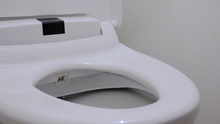 Toilet with Sanitary Bidet Water Sprayer. Installed So as to be More hygienic and use less toilet paper. Electronic Toilet popular in Japanese public facilities and general houses Royalty-Free Stock Footage #1066244332